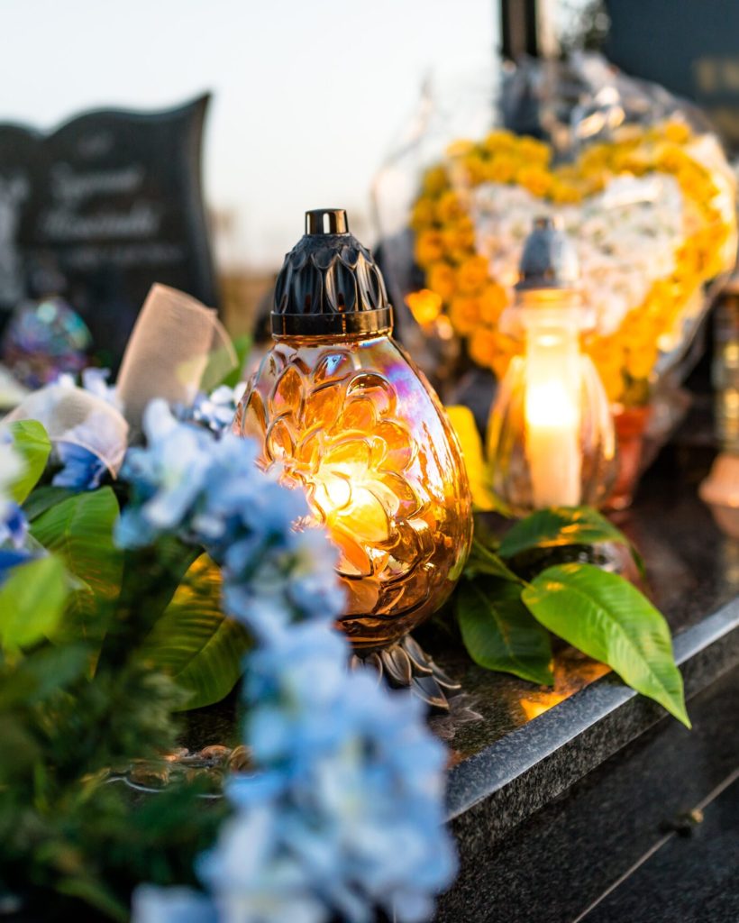 artificial-and-real-flowers-and-lit-candles-lying-2025-03-12-22-08-11-utc