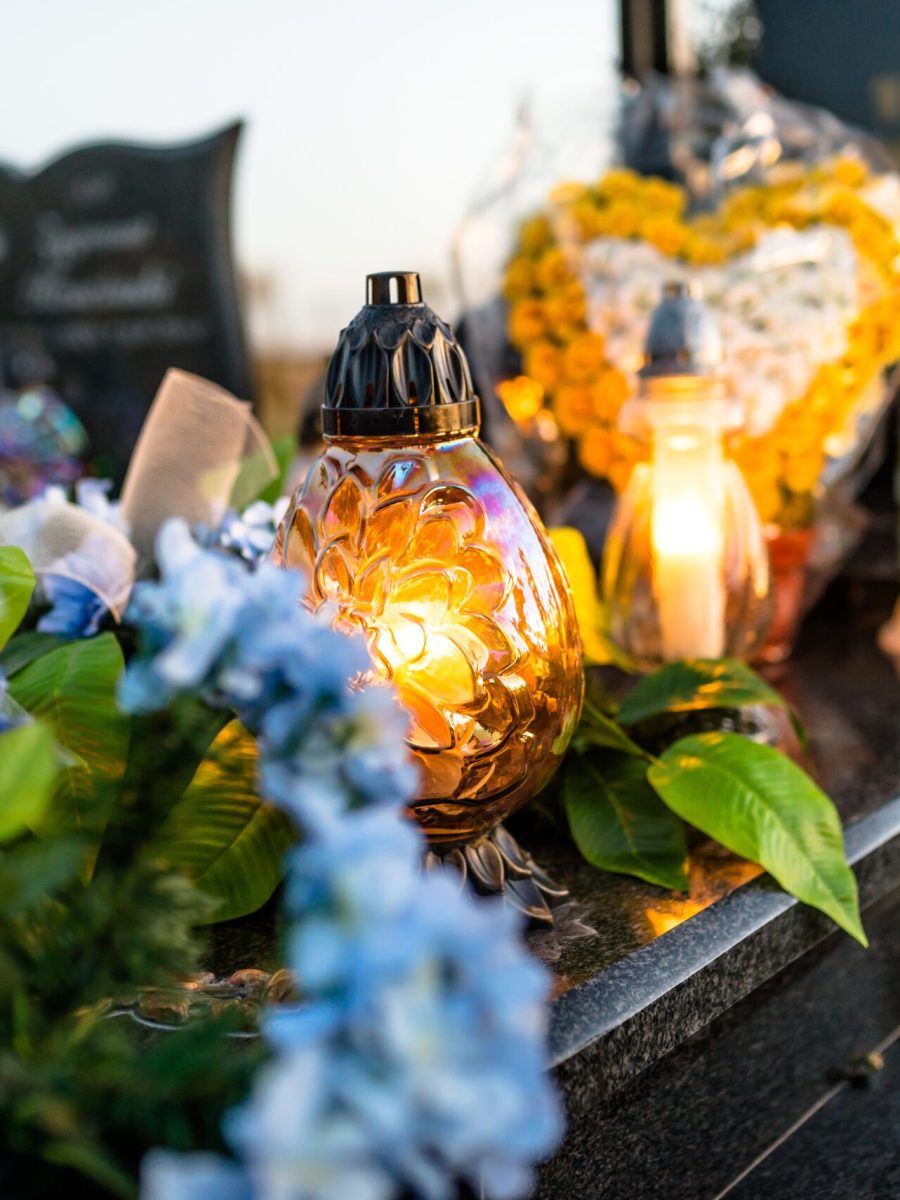 artificial-and-real-flowers-and-lit-candles-lying-2025-03-12-22-08-11-utc