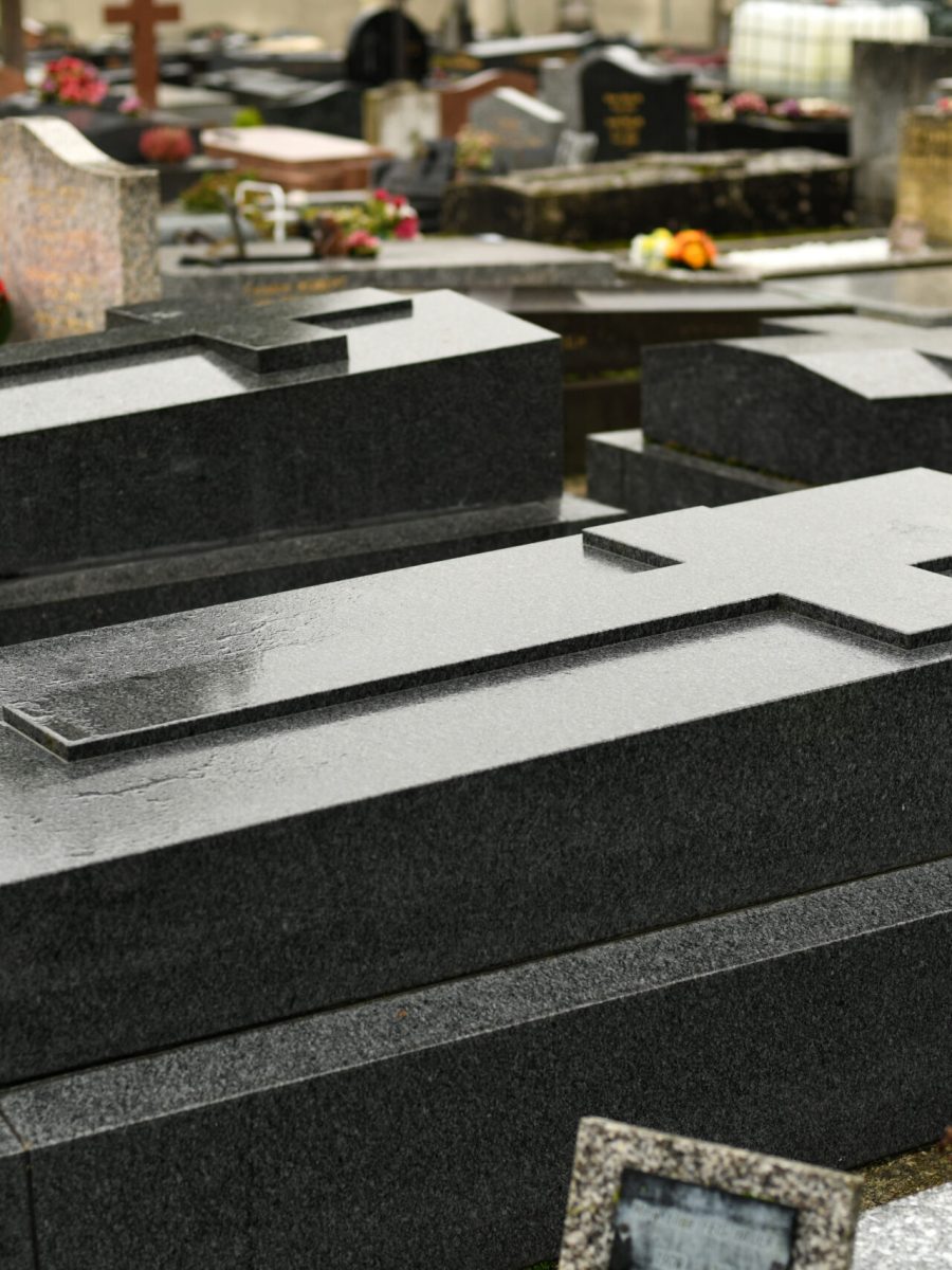 Cross on a marble slab on a grave in a cemetery