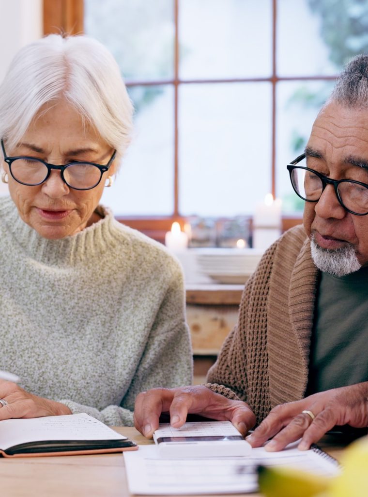 senior-couple-paperwork-and-contract-with-signature-and-life-insurance-information-for-will-and-po